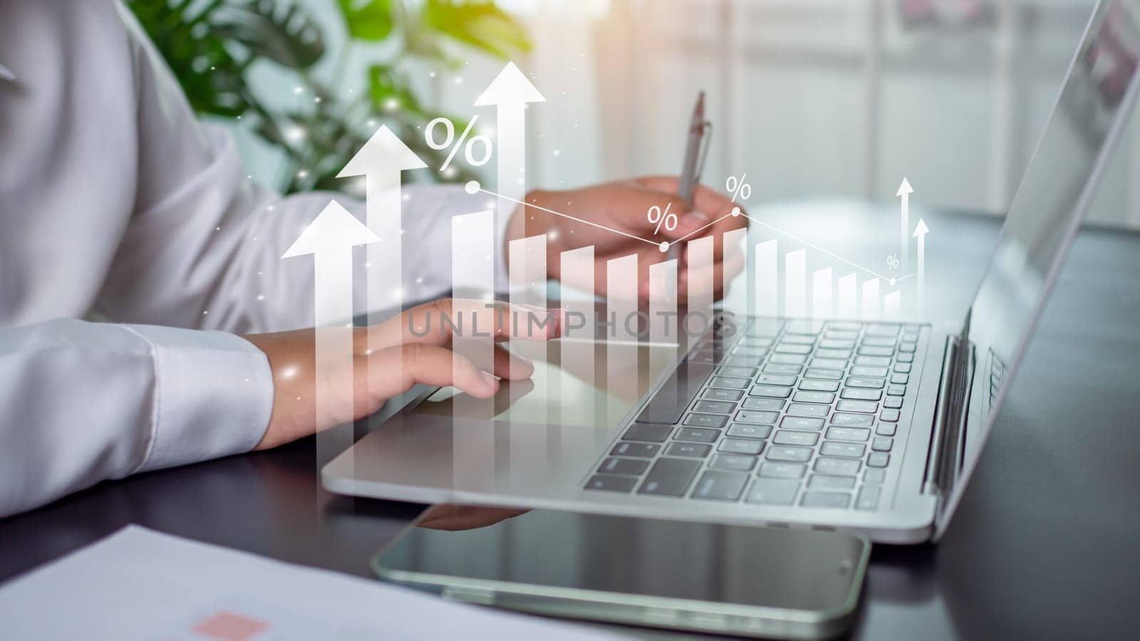 Businessman is using computer and showing graph with percentage sign for future business growth plan for business development concept for success and growth.