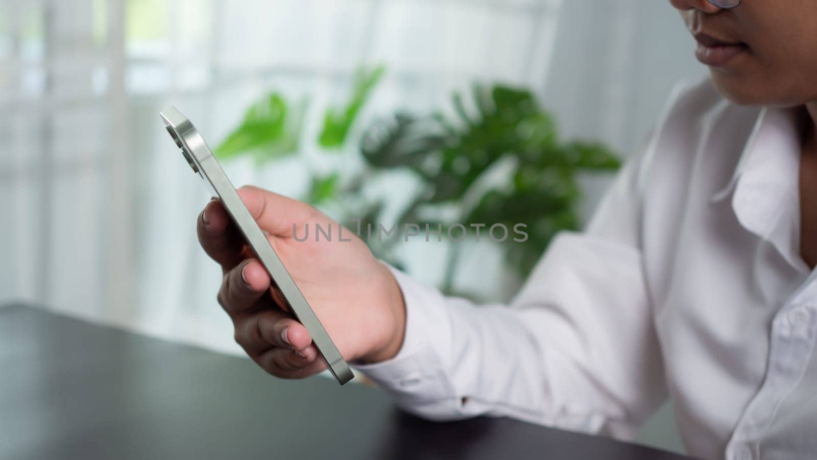 Asian woman holding a smartphone showing communication technology concept