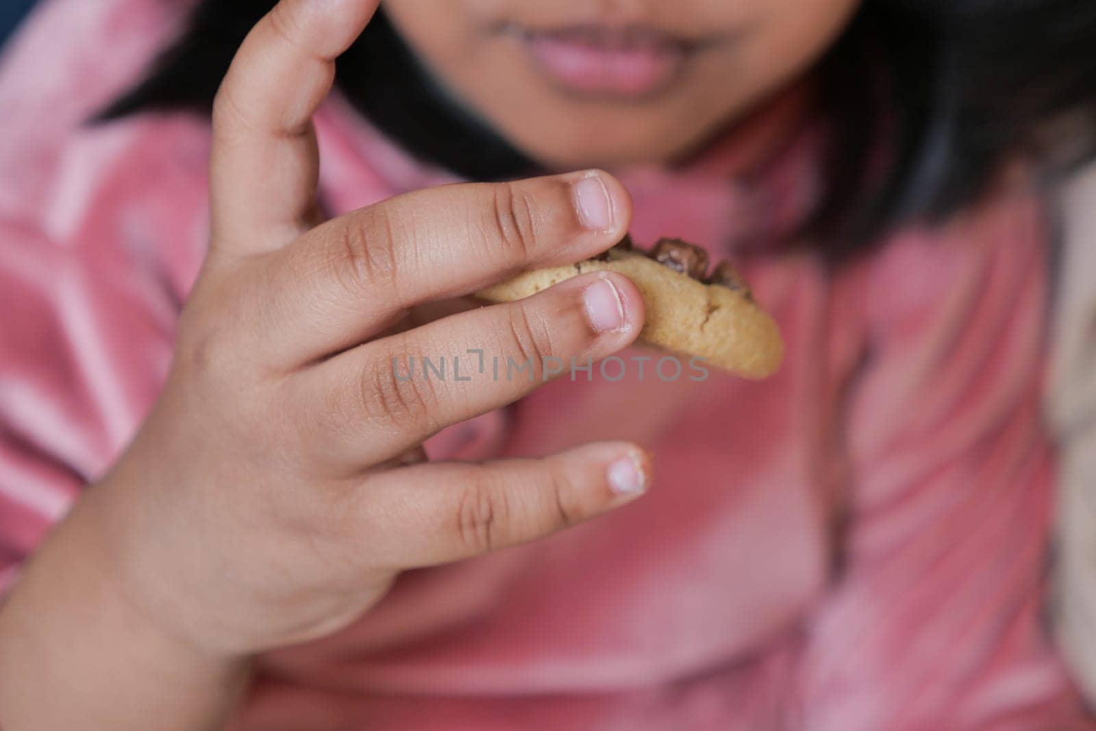 child eating sweet cookies closeup by towfiq007