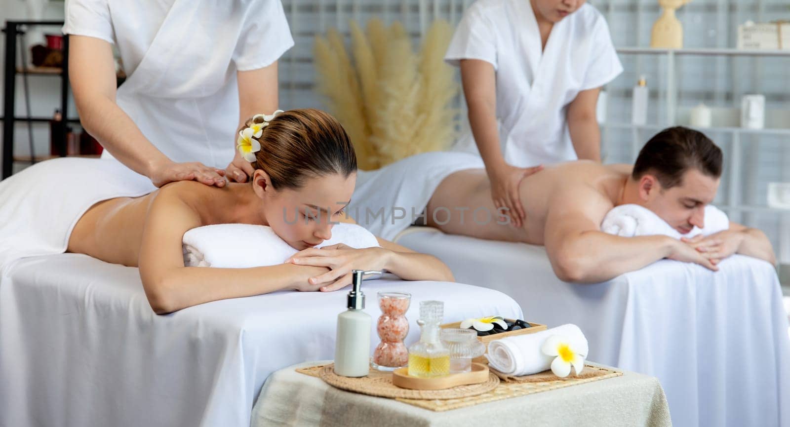 Caucasian couple customer enjoying relaxing anti-stress massage. Quiescent by biancoblue