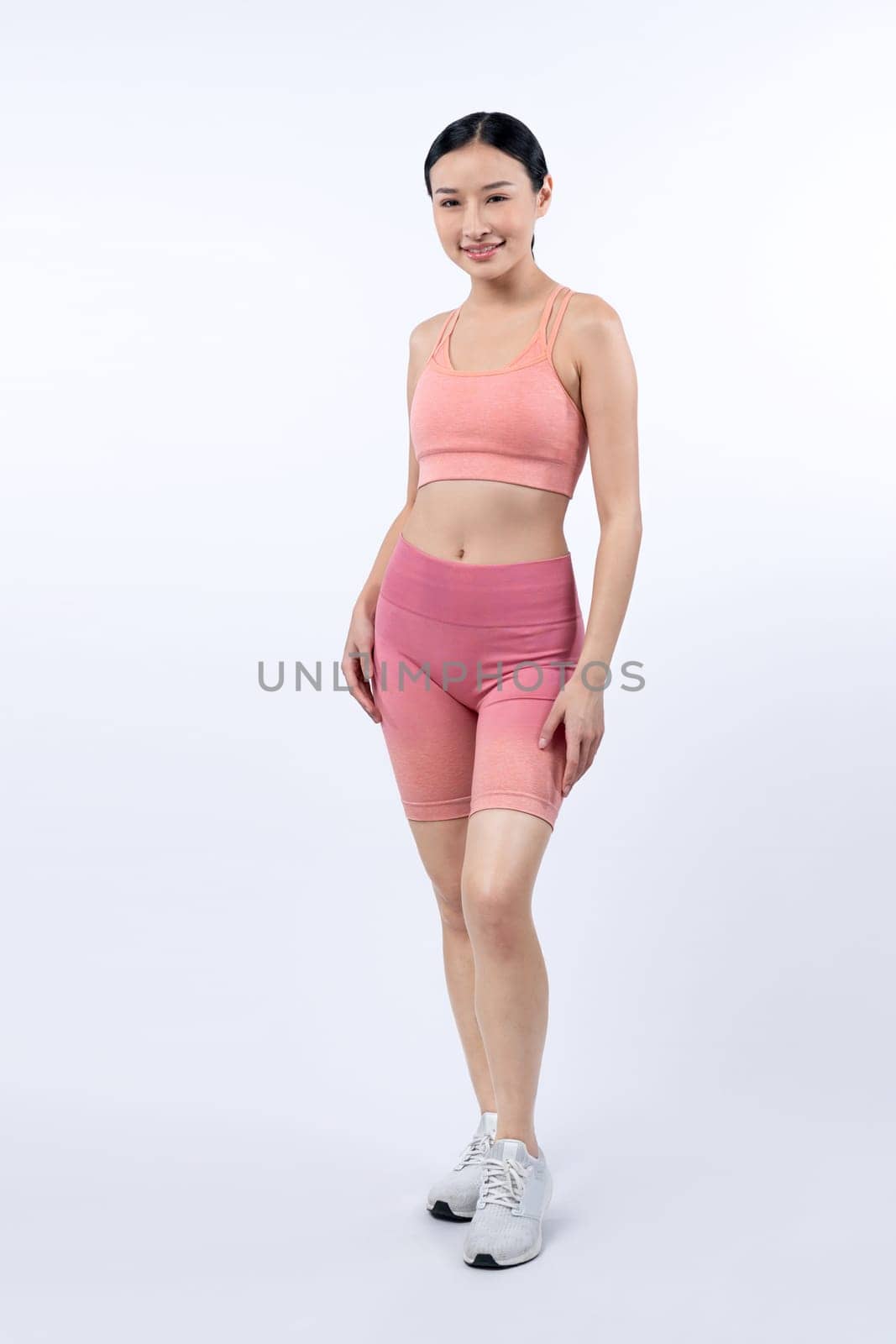 Full body asian woman in sportswear portrait, smiling and posing cheerful gesture. Workout training with attractive girl engage in her pursuit of healthy lifestyle. Isolated background Vigorous