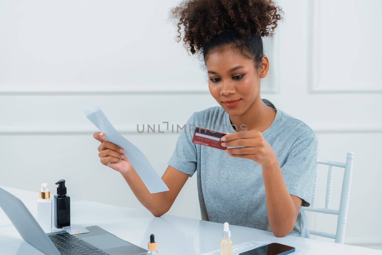 Young happy woman buy product by online shopping at home while ordering items from the internet with credit card online payment system protected by crucial cyber security from online store platform