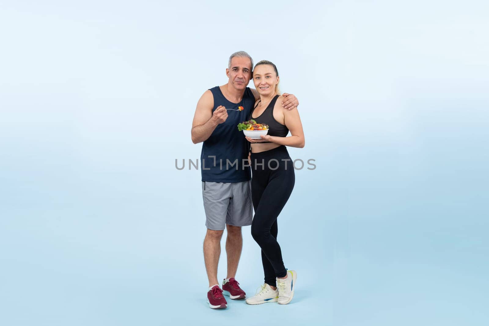 Happy smile senior man and woman portrait holding bowl of vegan fruit and vegetable on isolated background. Healthy senior couple with healthy vegetarian nutrition and body care lifestyle. Clout