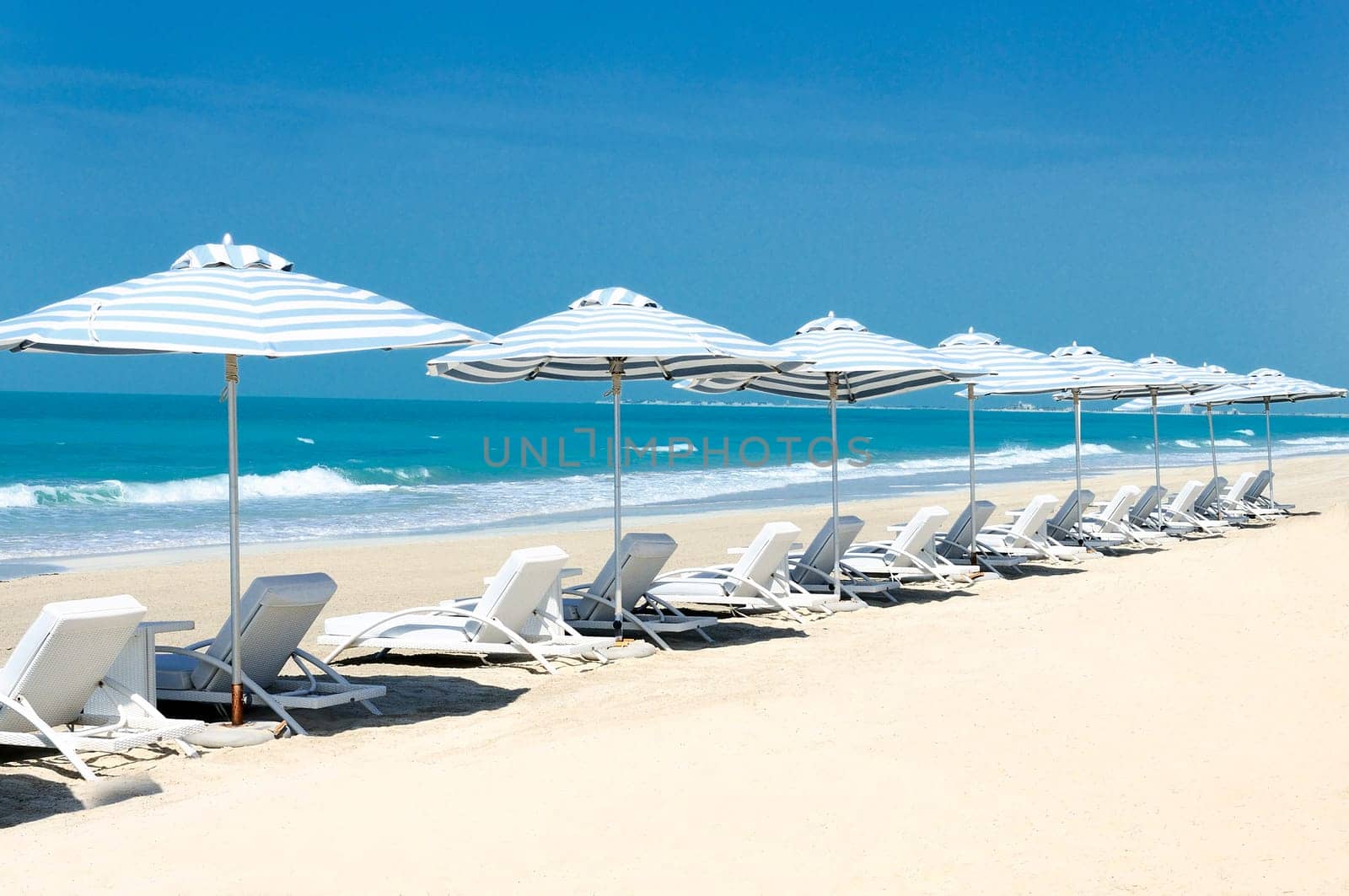 Panoramic view of chairs and nices umbrella on the beach