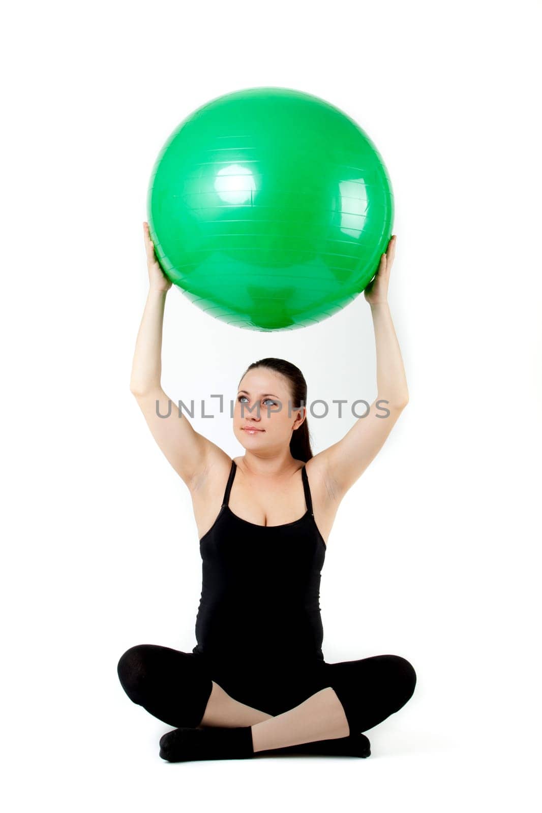 Pregnant woman excercises with gymnastic ball.