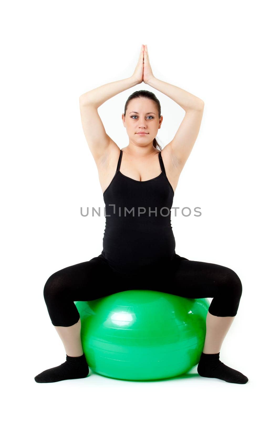 Pregnant woman excercises with gymnastic ball.