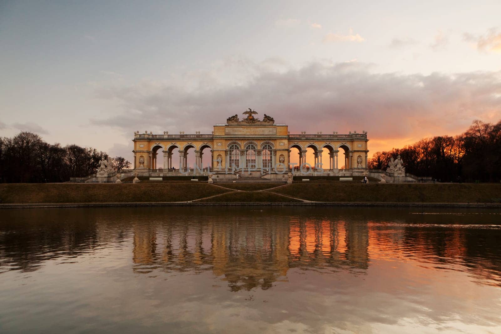 Gloriette Vienna,building and landmark in front of pond with sunset