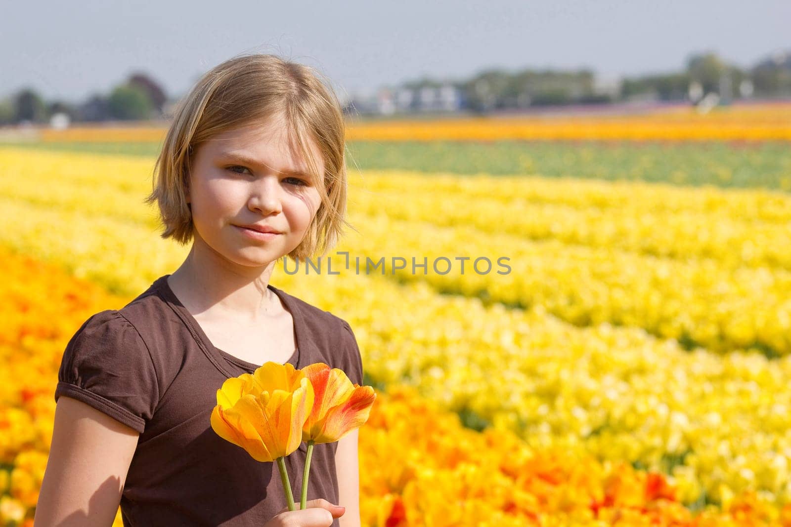 little girl in tulips field