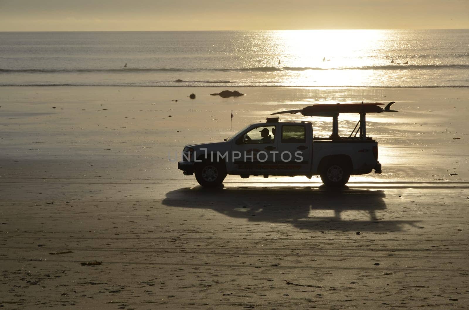 Sunset with baywatch car at the beach of San Diego