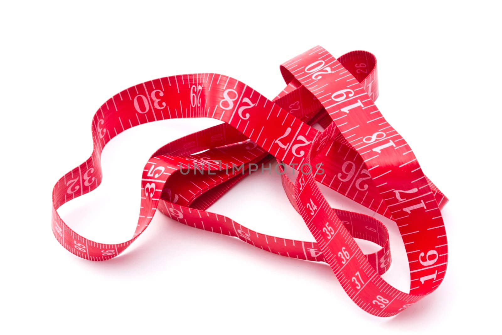 Red tape measure closeup on white background
