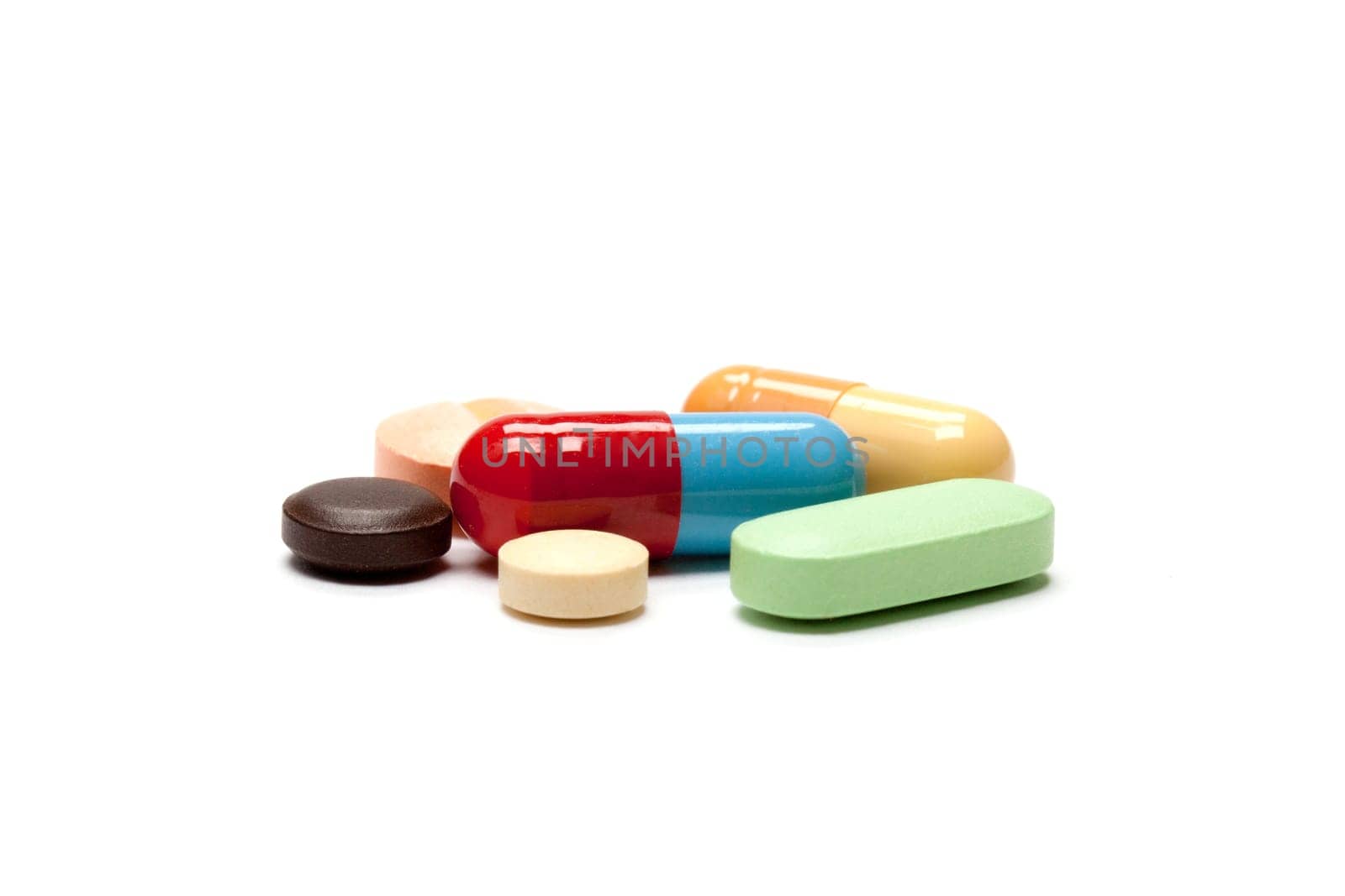 Tablets,different pills in different colors against white background