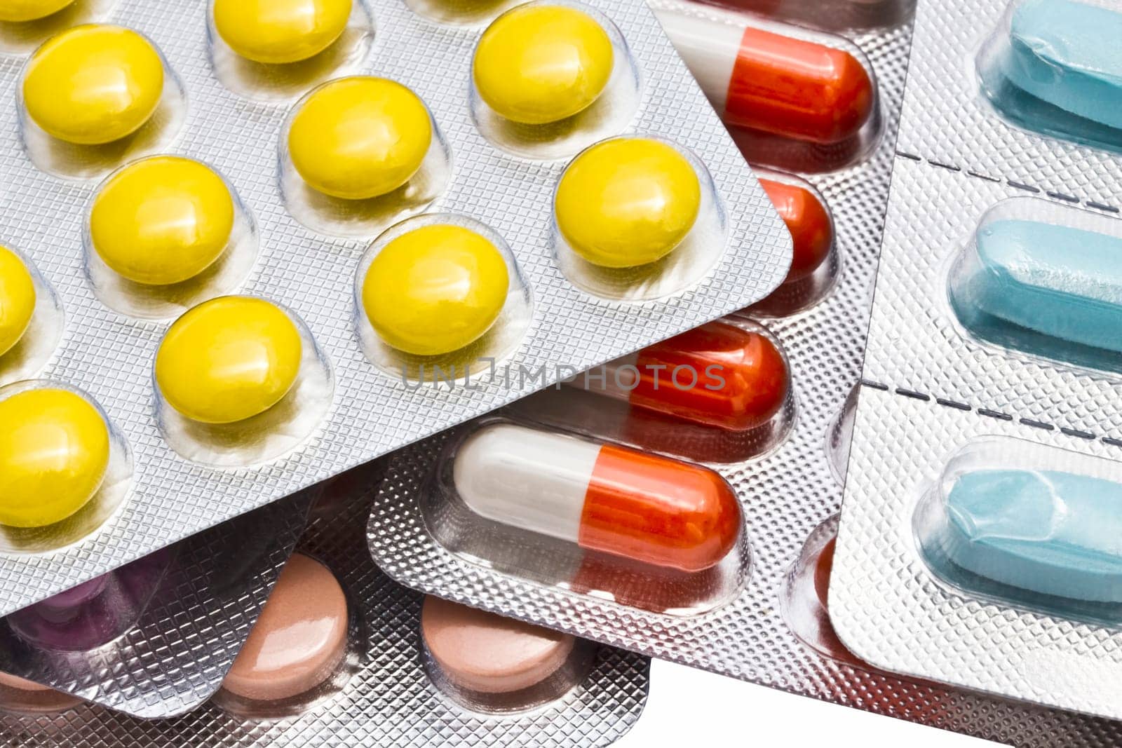 Colorful pills closeup on white background