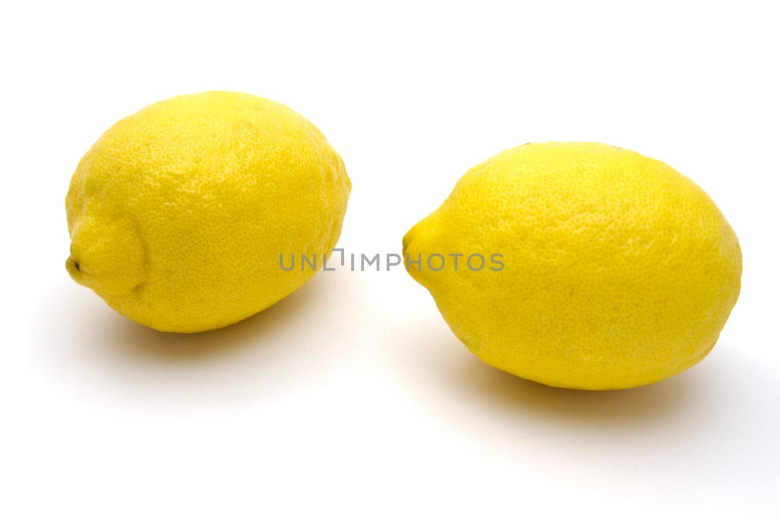 Two Fresh lemons closeup on white background