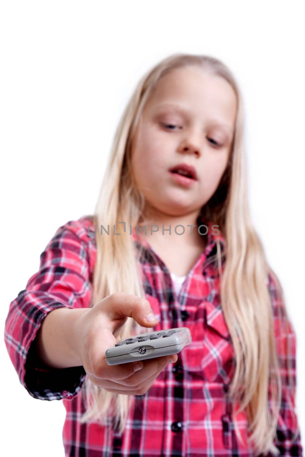 a little girl holds the TV remote control