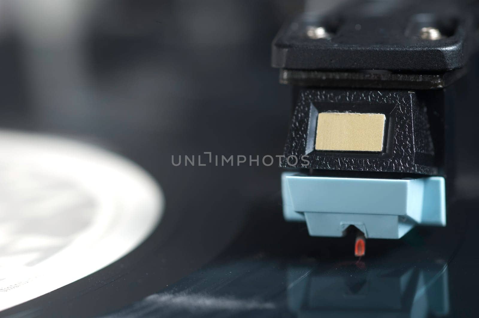 Close up of Record Player with Focus on Arm and Needle.