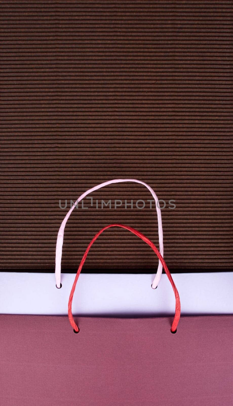 Paper bag with handles on brown corrugated cardboard