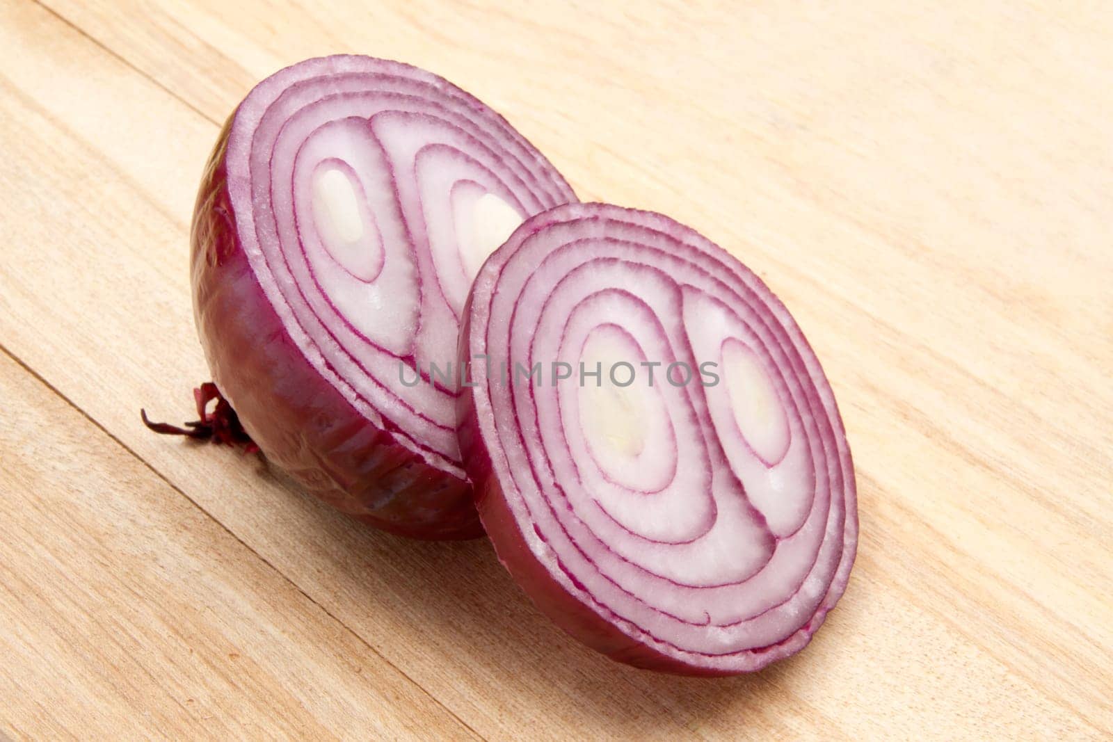 Red onion isolated on wood background