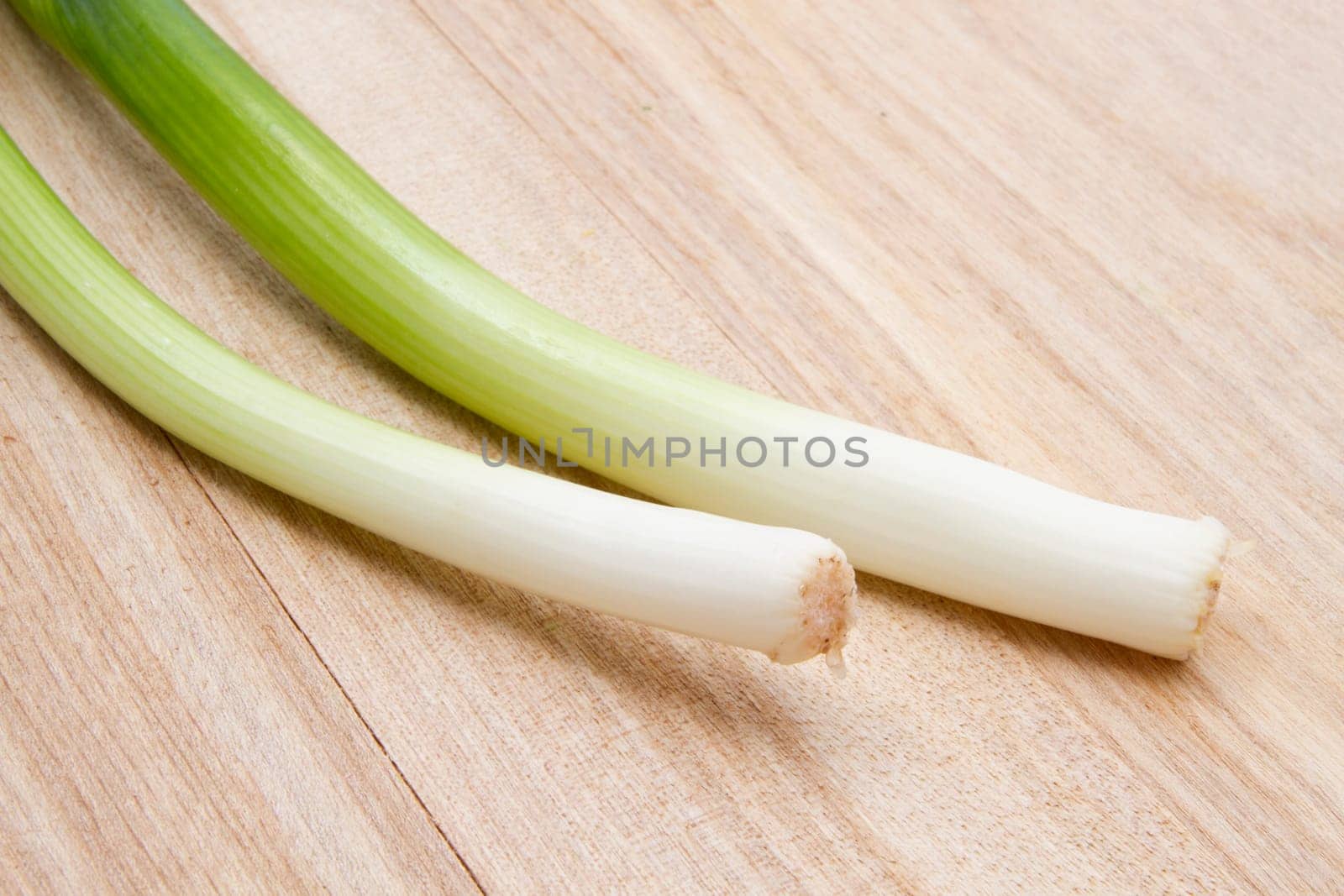 Fresh green onion isolated on wood background