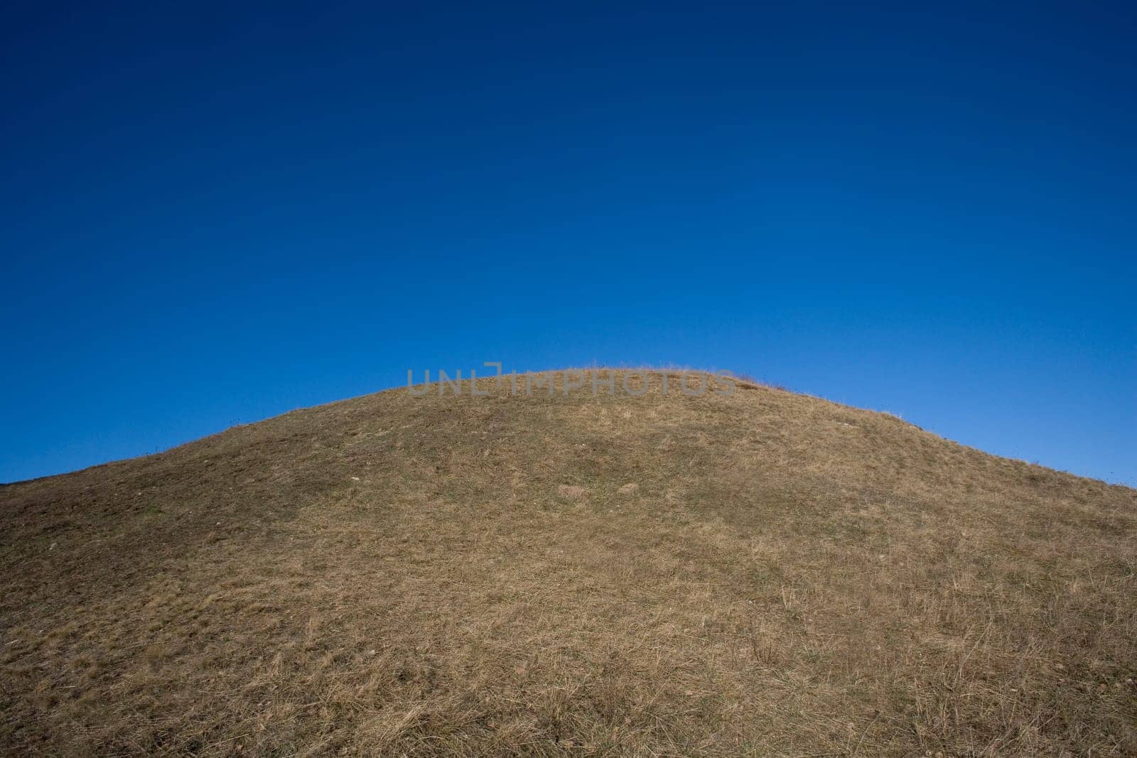 Hill towards dark blue sky