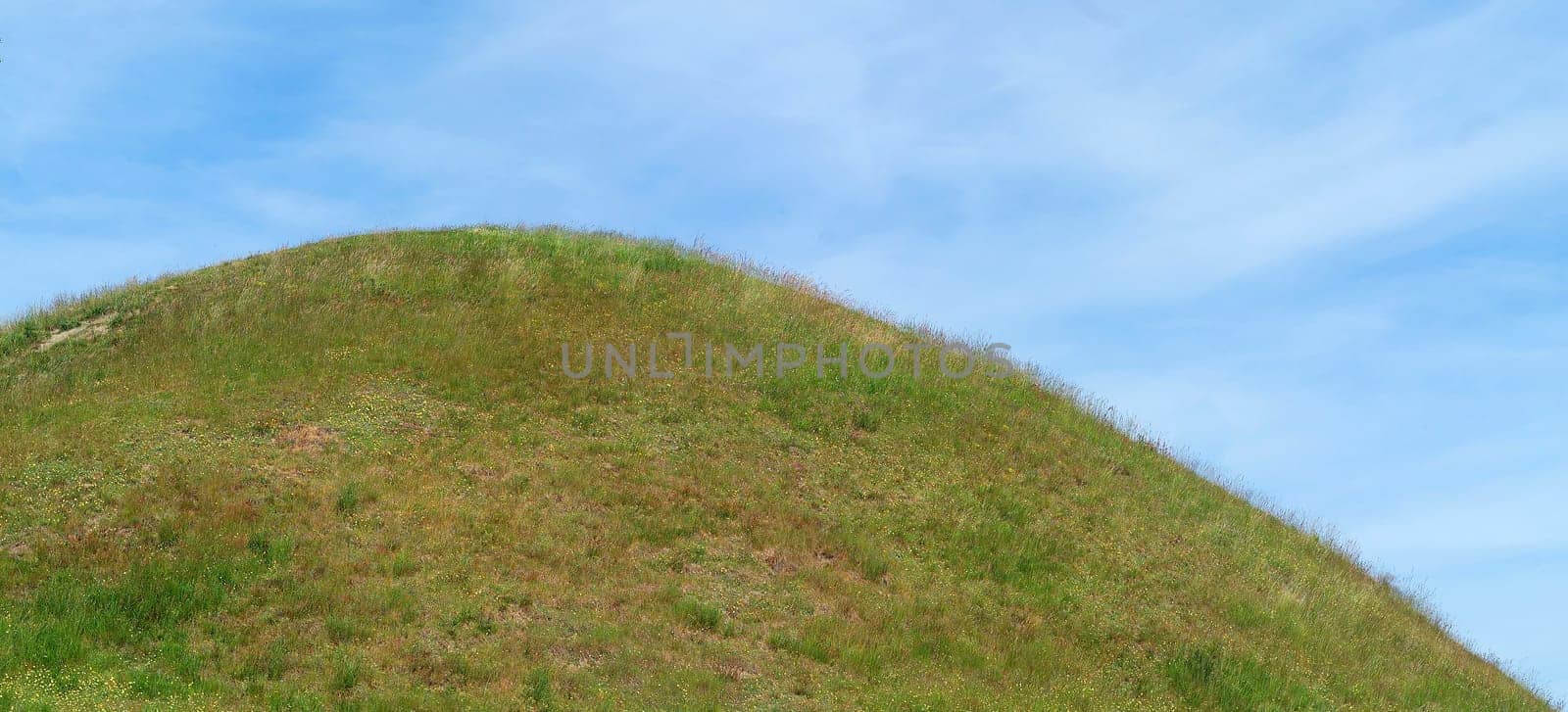 Green Hill in front of Blue sky