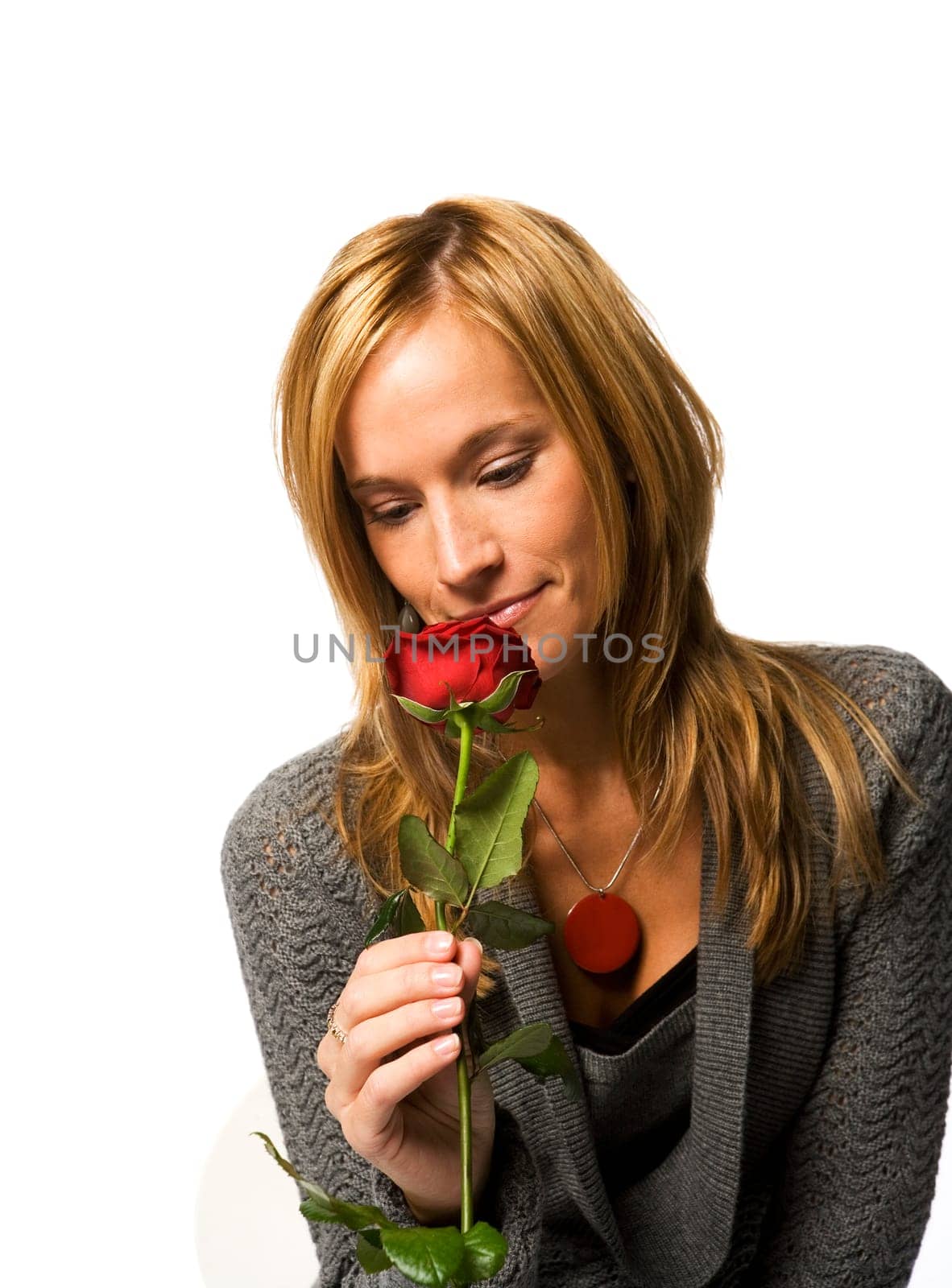Young woman with a red rose on white background