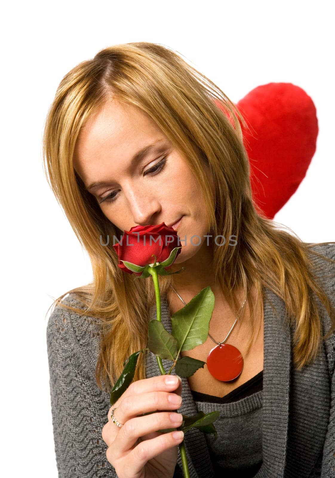 Young woman with a red rose on white background
