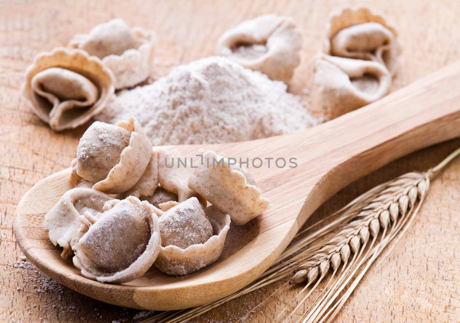 Fresh raw capeletti with flour close up shoot