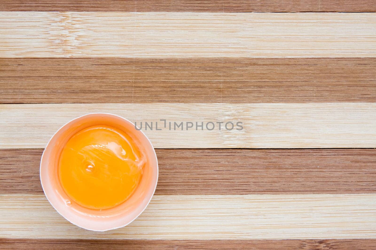 single raw egg on a wooden background