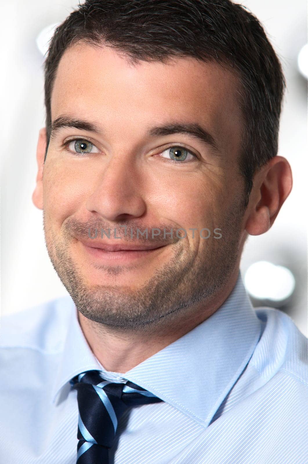 An attractive business man in a light business environment