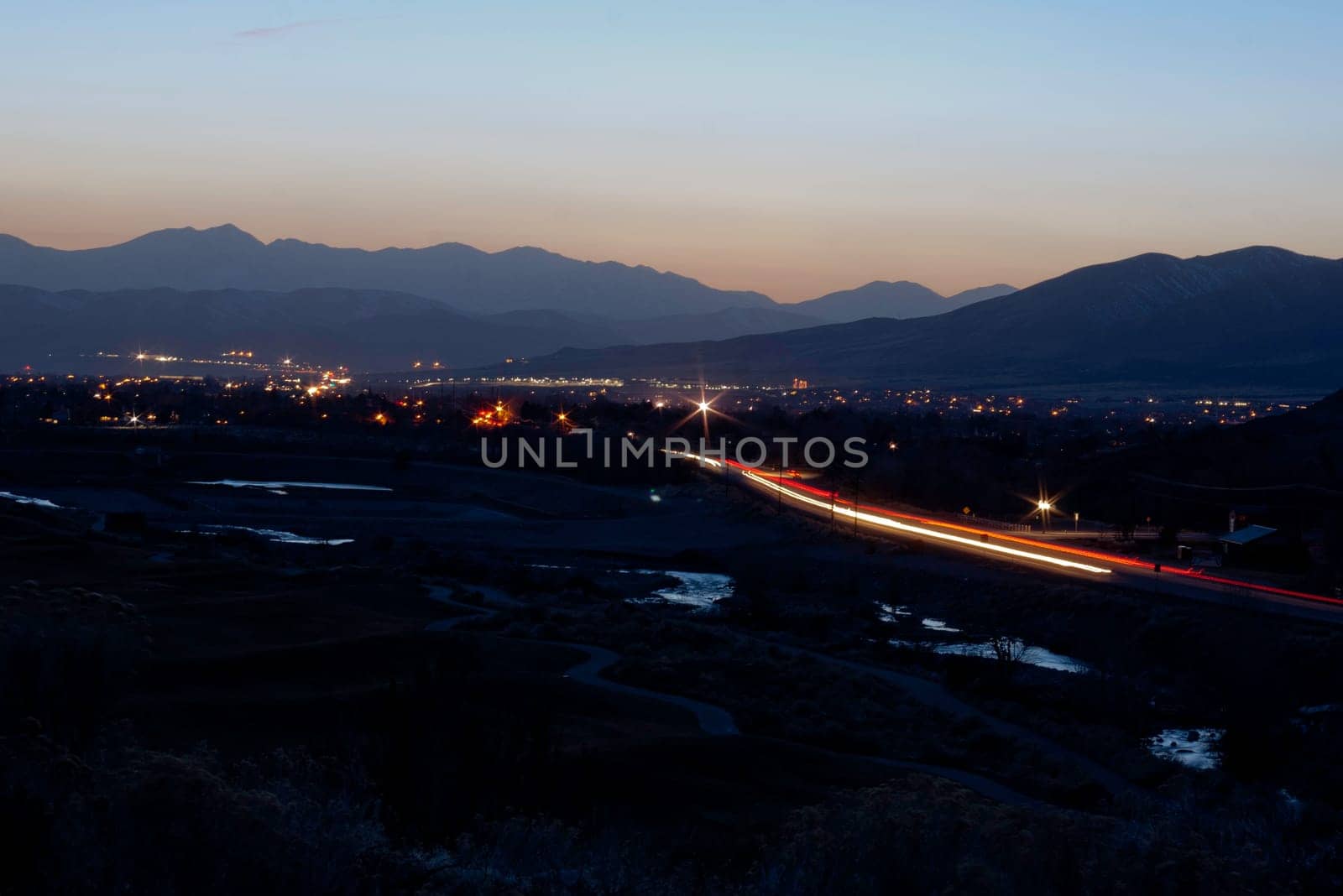 looking down over river and traffic blur and city scape sunset