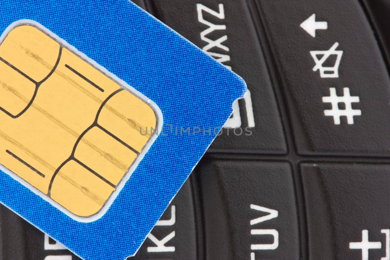 gsm  sim card on  the top of a phone keypad