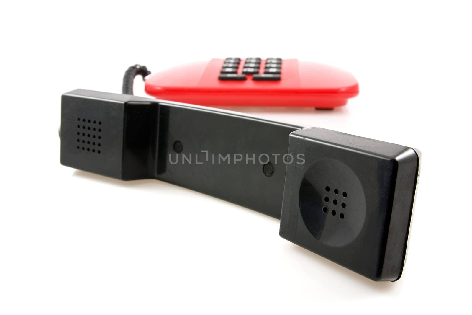 red telephone with black receiver over a white background