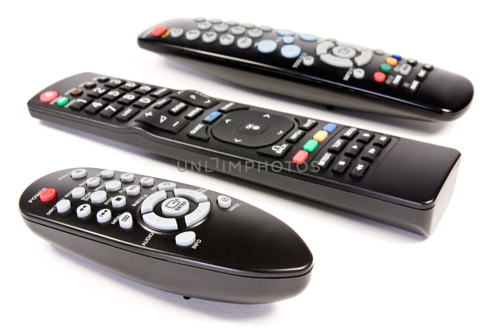 three remote controls over a white background