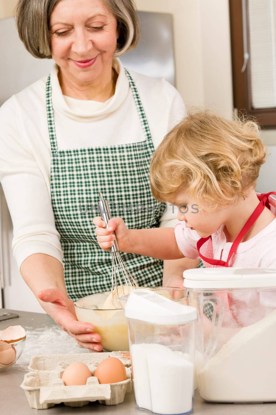 Grandmother and granddaughter baking cookies prepare dough