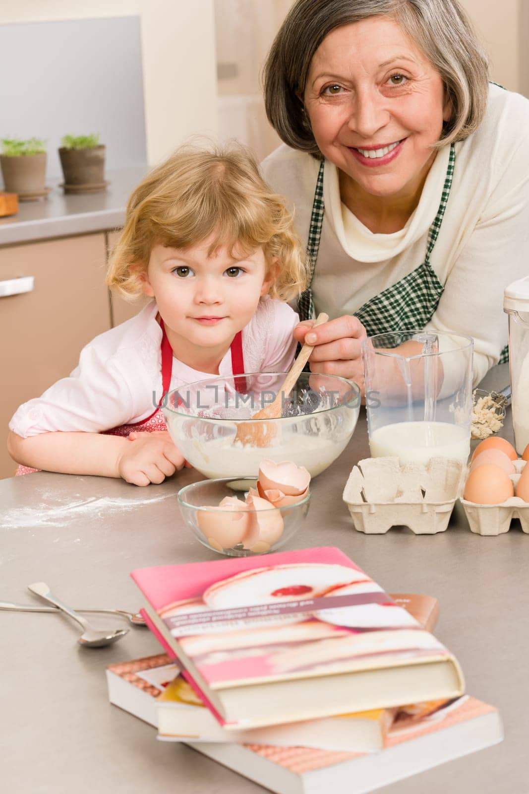 Child girl and grandmother baking cake stir dough