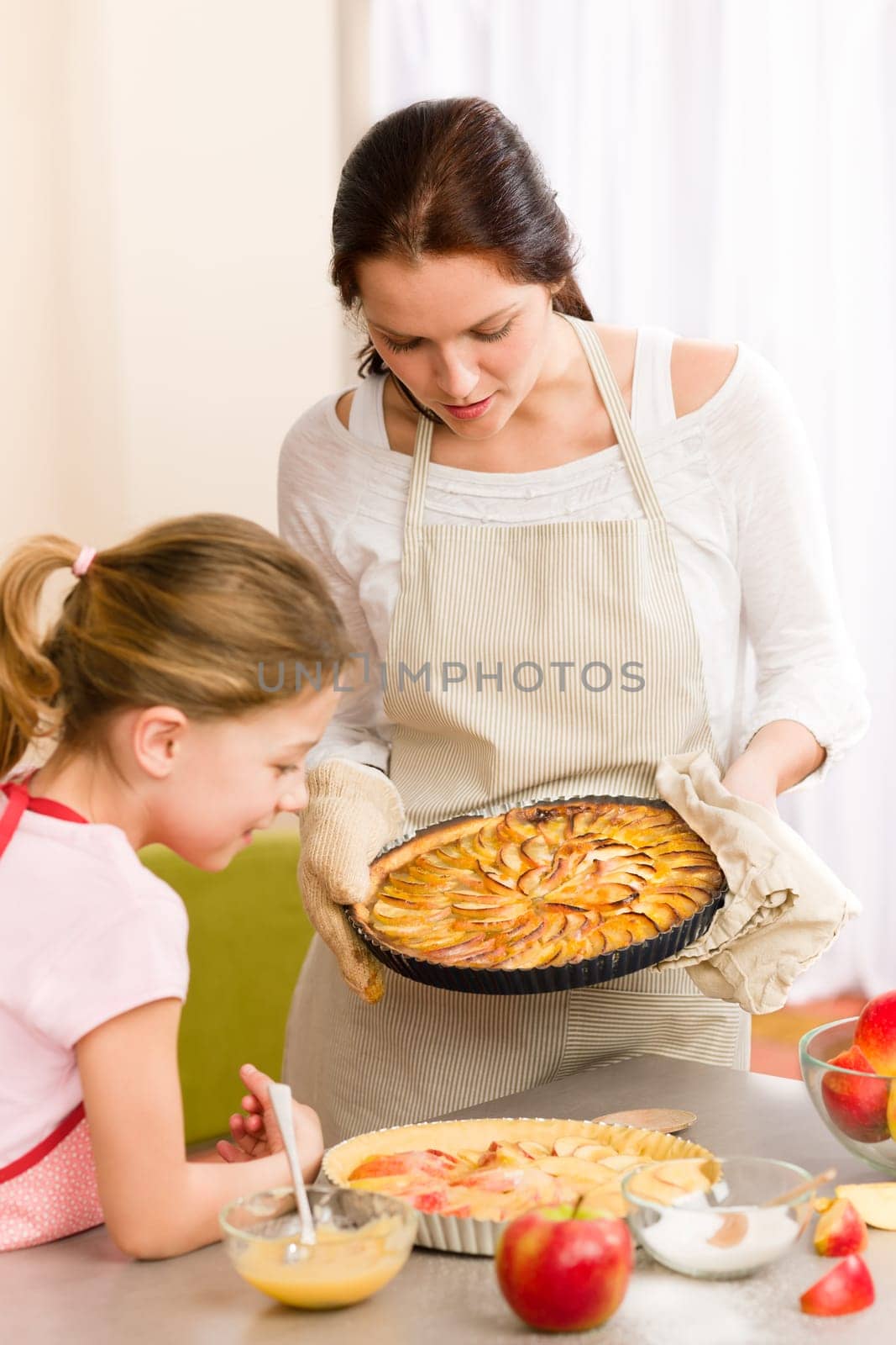 Apple pie mother and daughter baking together happy at home