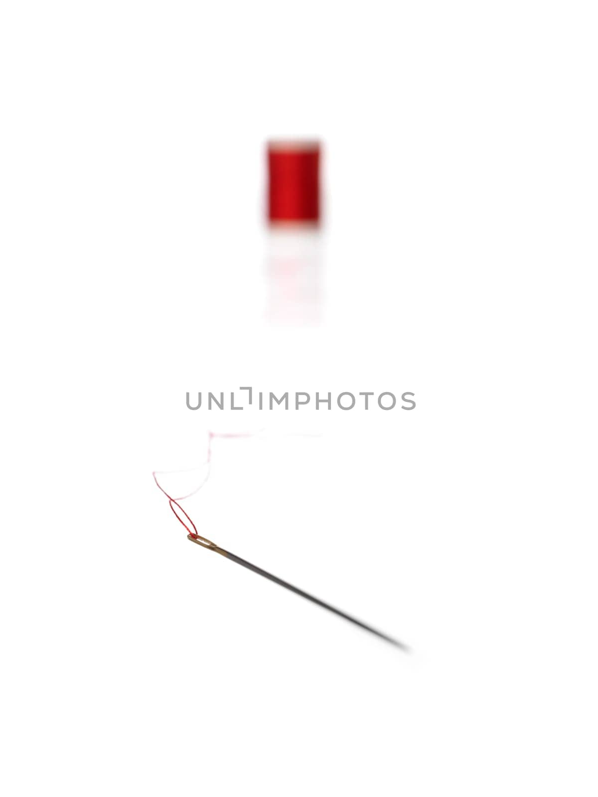 Thread Reel and nedle on white background