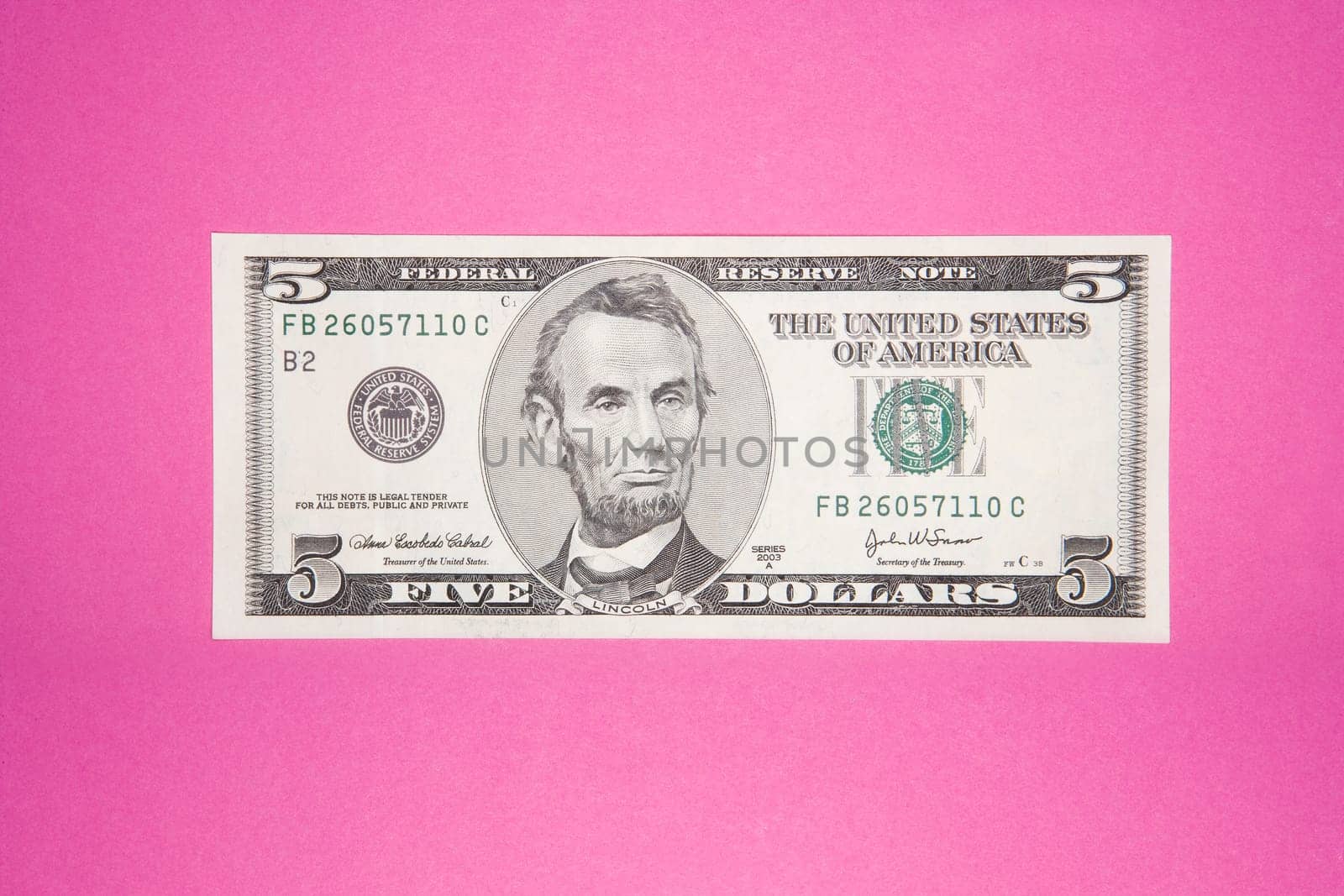 Five Dollar Bank Note on Pink Background
