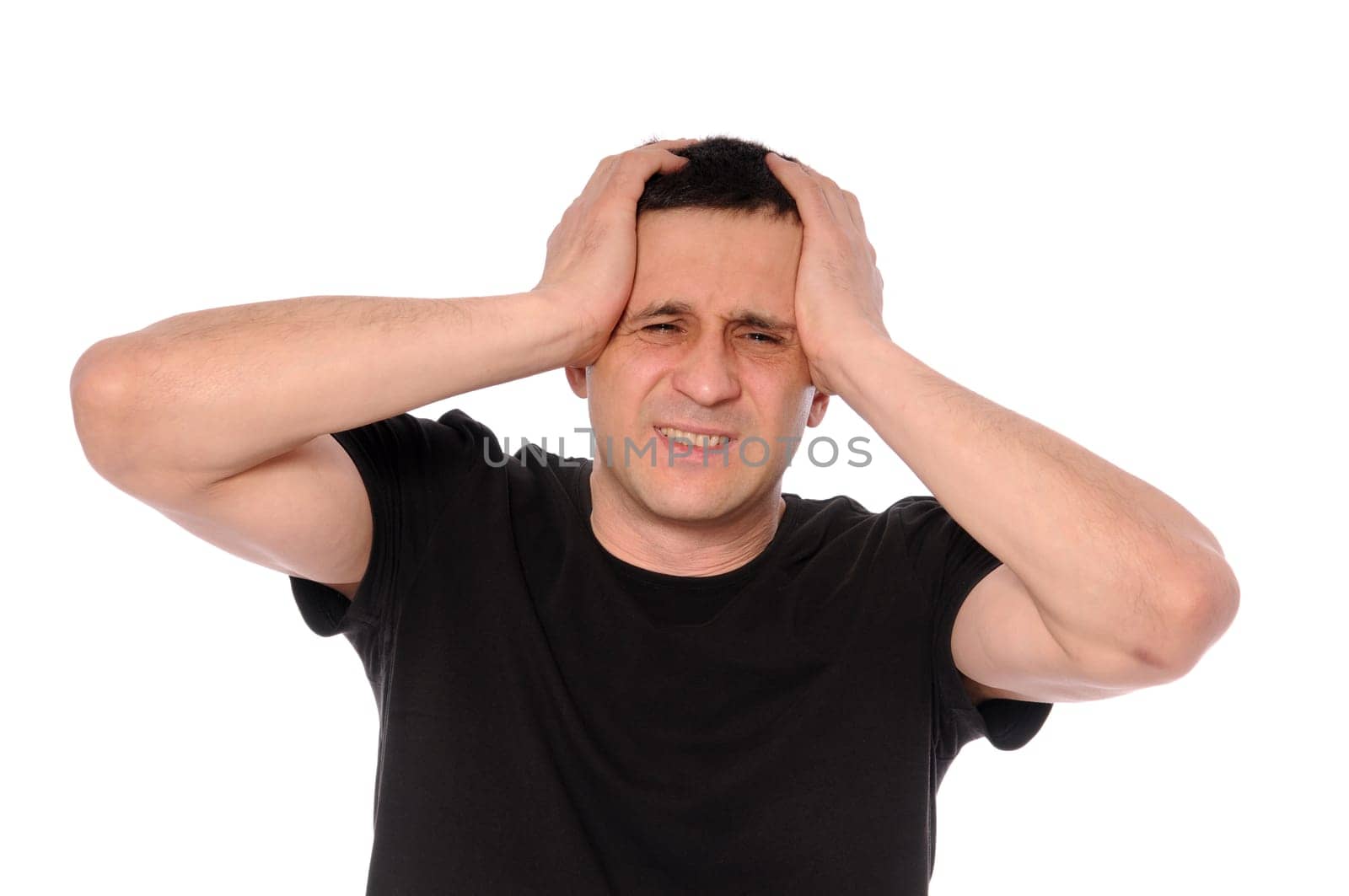 a man in a black t-shirt clings to head in his hands