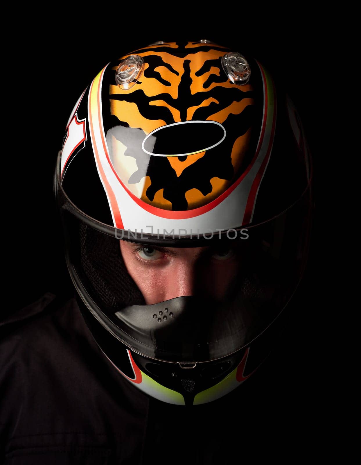 Man with motorcycle helmet on black background