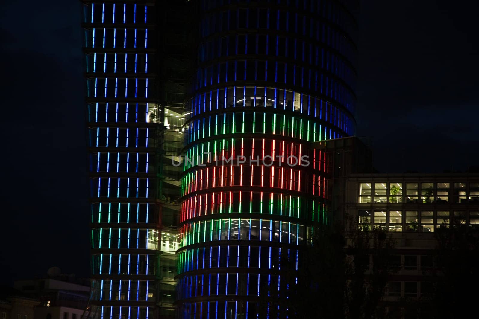 glas front of the Uniqa tower in vienna illuminated with different colors ans special effects by night, Vienna