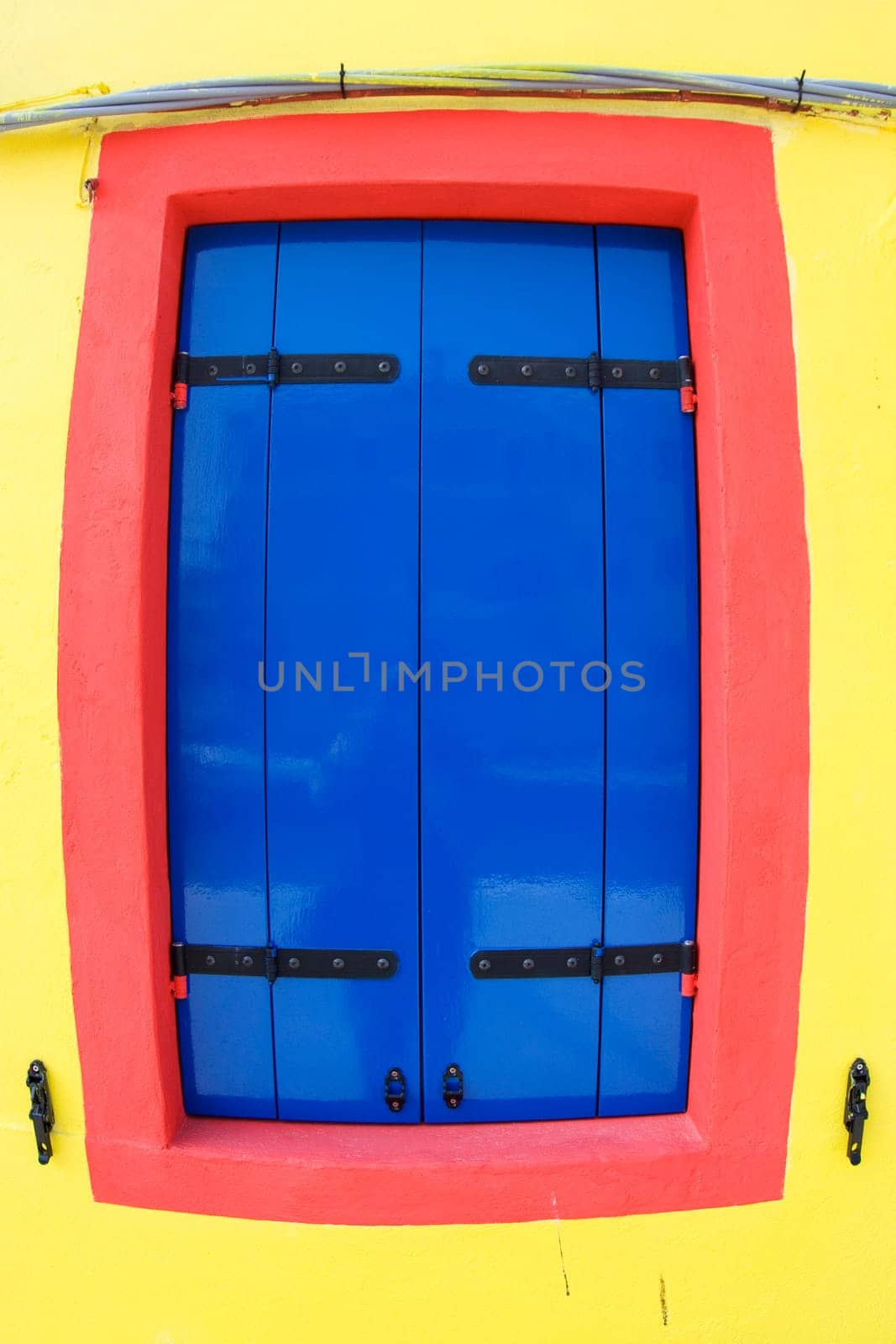 colorful facade of an old fisher house in the village of Burano near Venice