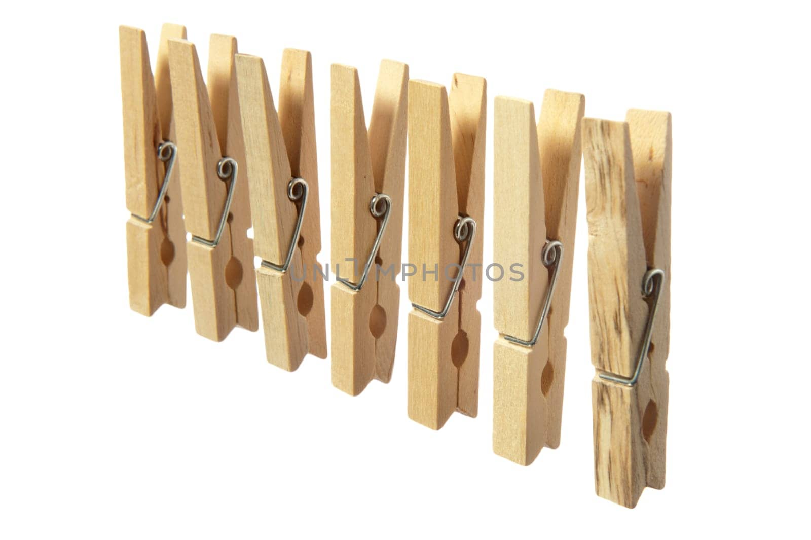 some wooden clothespins on a  white background