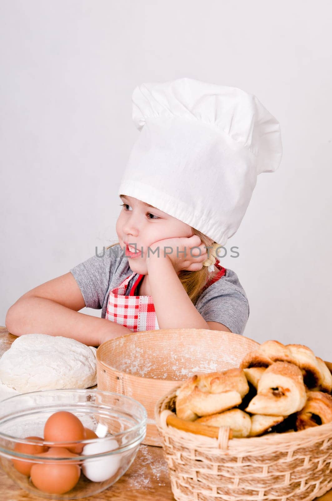 Chef Girl sitting at the table and thinks