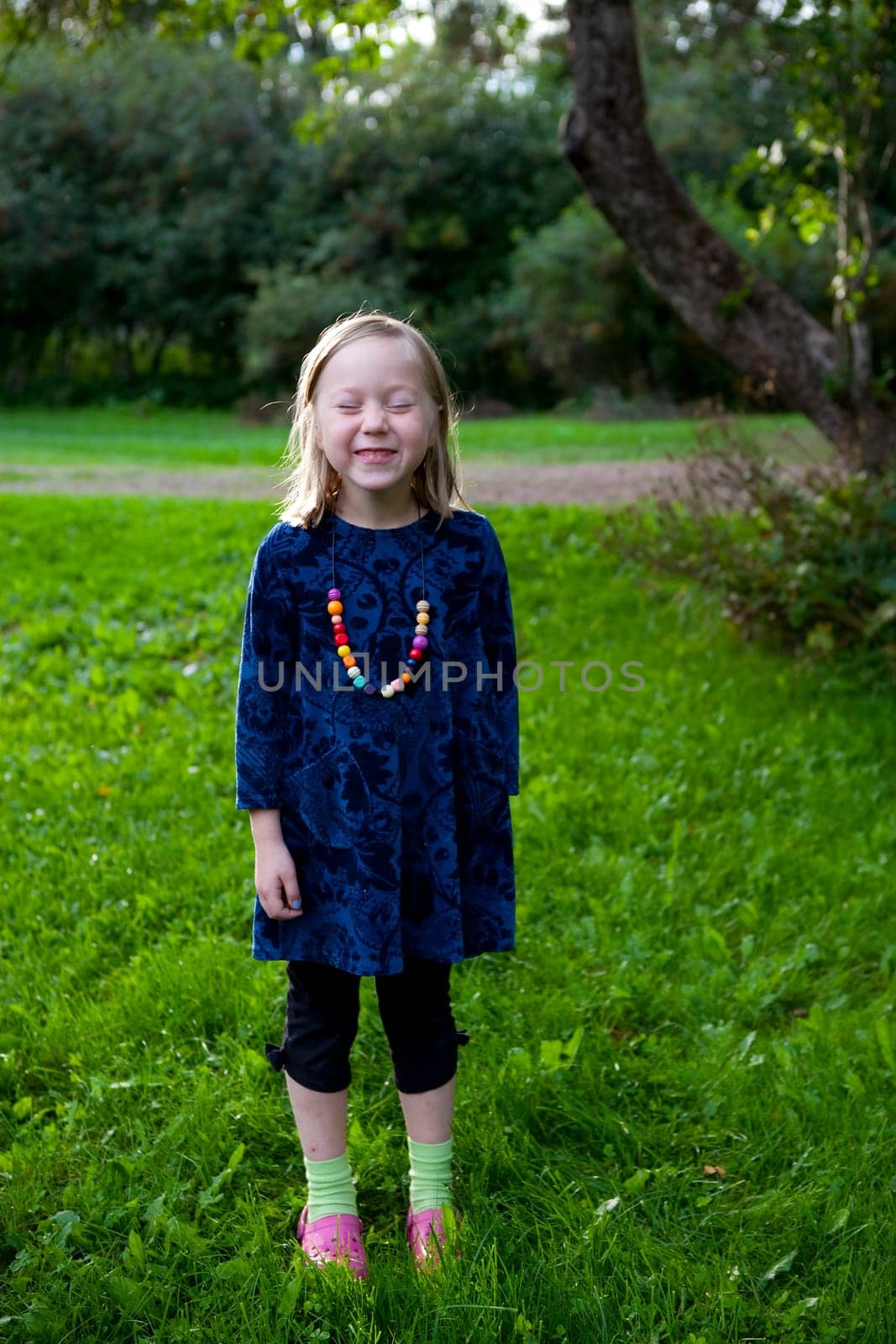 Little girl outdoors on a beautiful summer afternoon