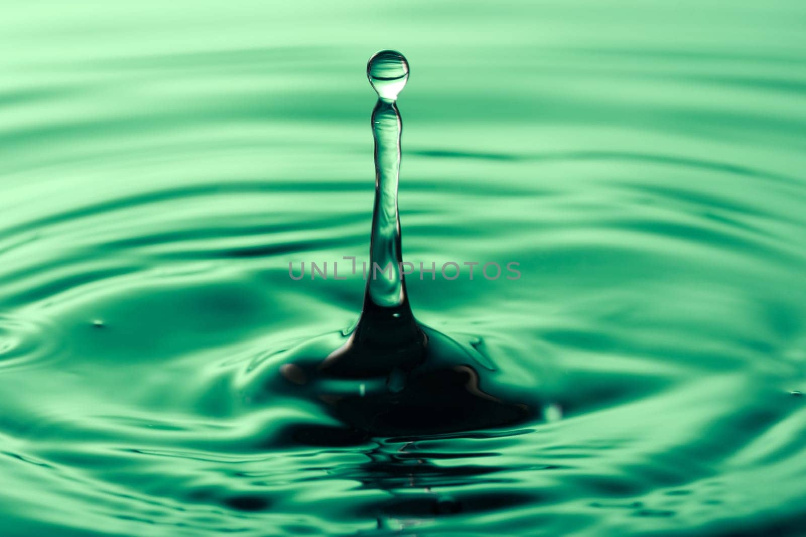 tranquility concept. drop falling into green  water