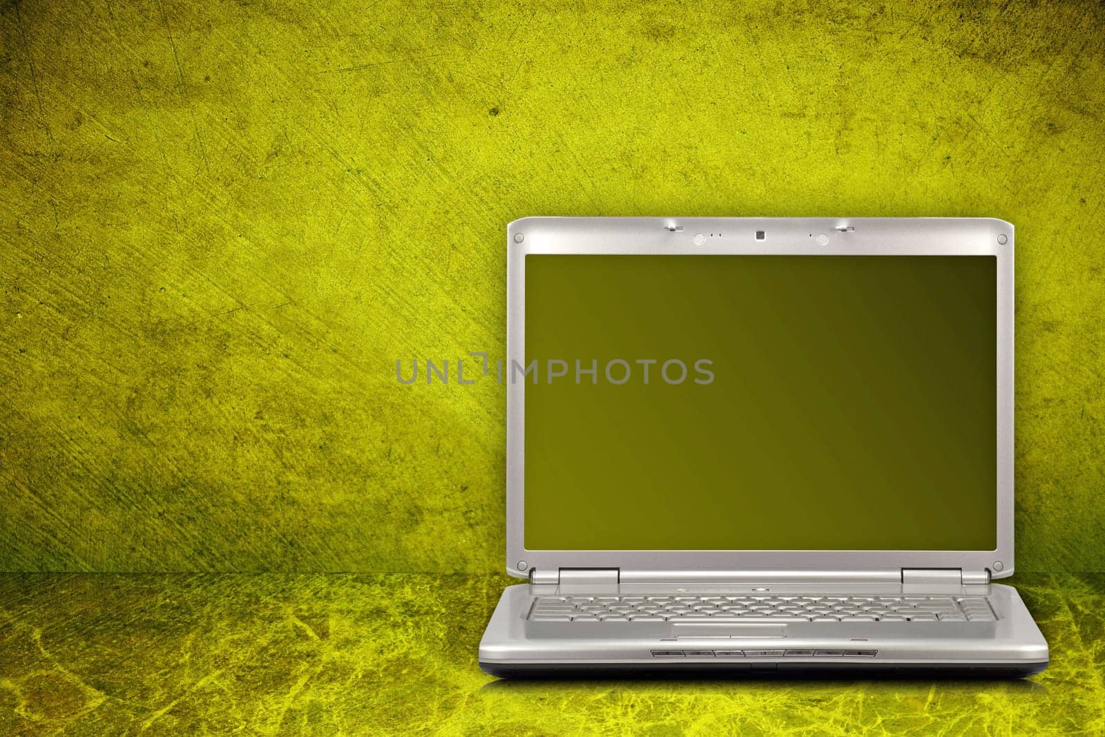silver computer on green and dirty background