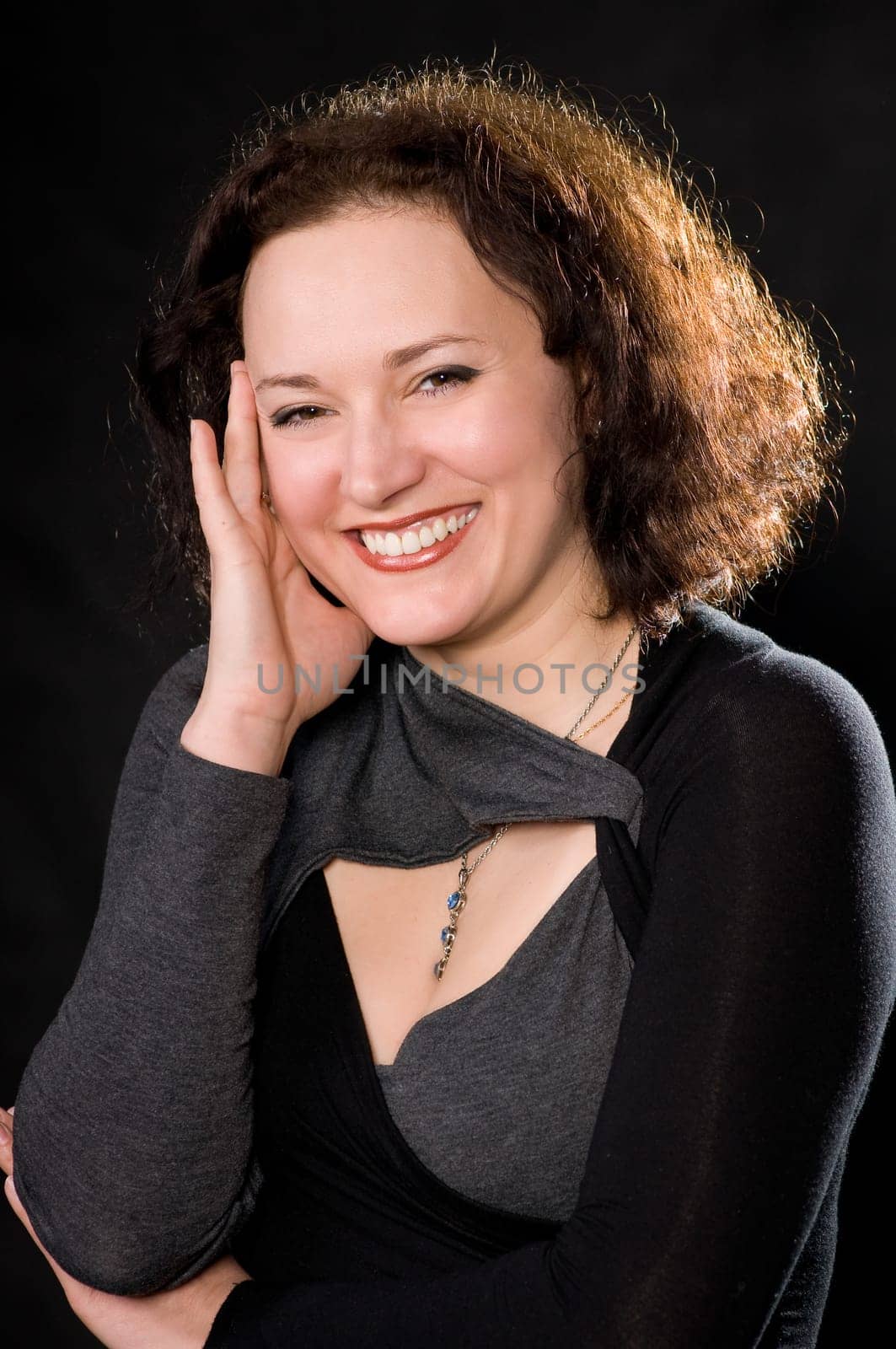 portrait of smiling woman on dark background