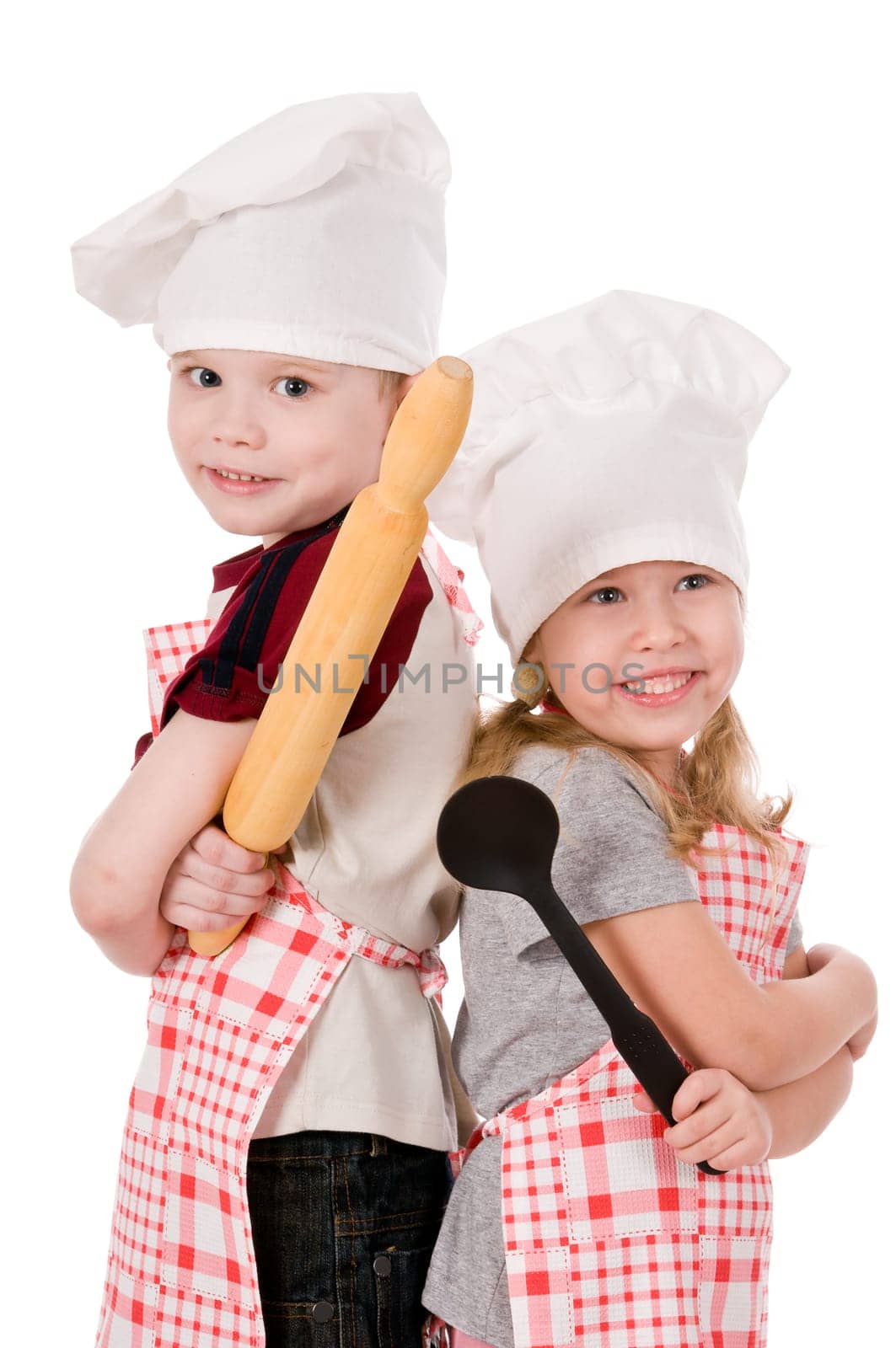 two children in chef&#039 s hat isolated on white background