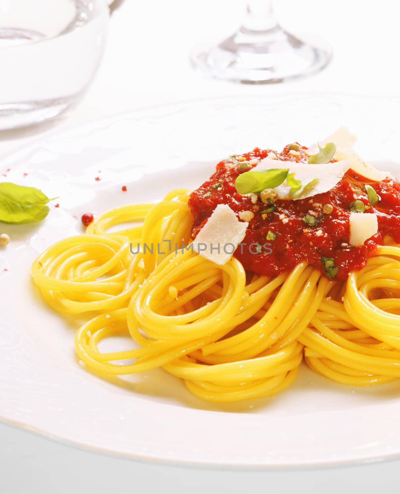 Plate of freshly prepared spaghetti bolognaise with a tomato sauce and cheese ready to be served.